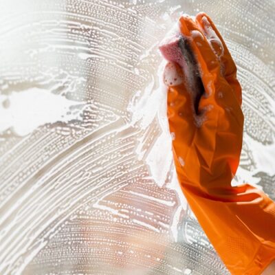 close-up-cleaning-window-with-sponge-min