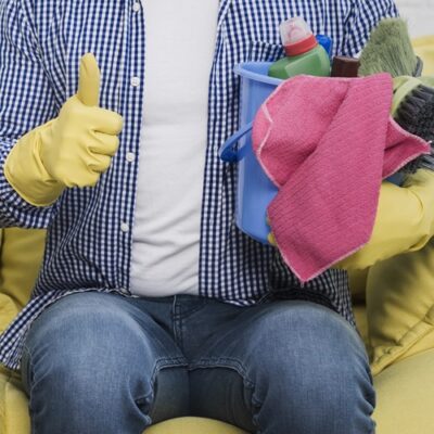 man-giving-thumbs-up-while-holding-bucket-with-cleaning-products-min